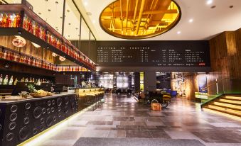 The restaurant features an interior design with spacious tables and chairs, complemented by a well-lit bar at CitiGO Hotel, West Nanjing Road, Jing'an Temple, Shanghai