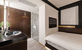 elegant, contemporary bedroom with a spacious bed and a separate bathroom, featuring a wall adorned with decorative elements at CitiGO Hotel Jing'an Shanghai