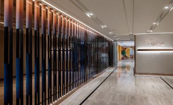 The interior of the building features walls and floors adorned with a series of large windows that allow natural light to illuminate the space at Park Hotel Hong Kong