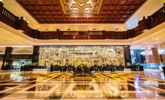 The lobby and main entrance of a large building feature marble floors and ceiling lights on both sides at LN Garden Hotel Guangzhou