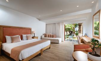 a modern hotel room with wooden floors , white walls , and large windows offering views of the outdoors at Civitel Creta Beach