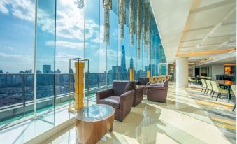 A room on an upper level with large windows and floor-to-ceiling glass provides a city view at The Eton Hotel Shanghai