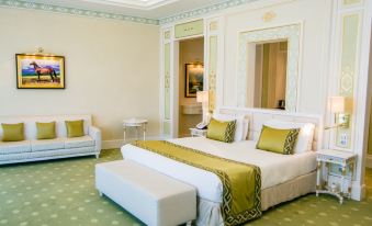 In the middle room, there is a large bed with two lamps and a table on each side that match at Yyldyz Hotel