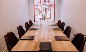 A spacious meeting room with a long wooden table and chairs is available for business meetings or conferences at Empire Hotel Kowloon－Tsim Sha Tsui