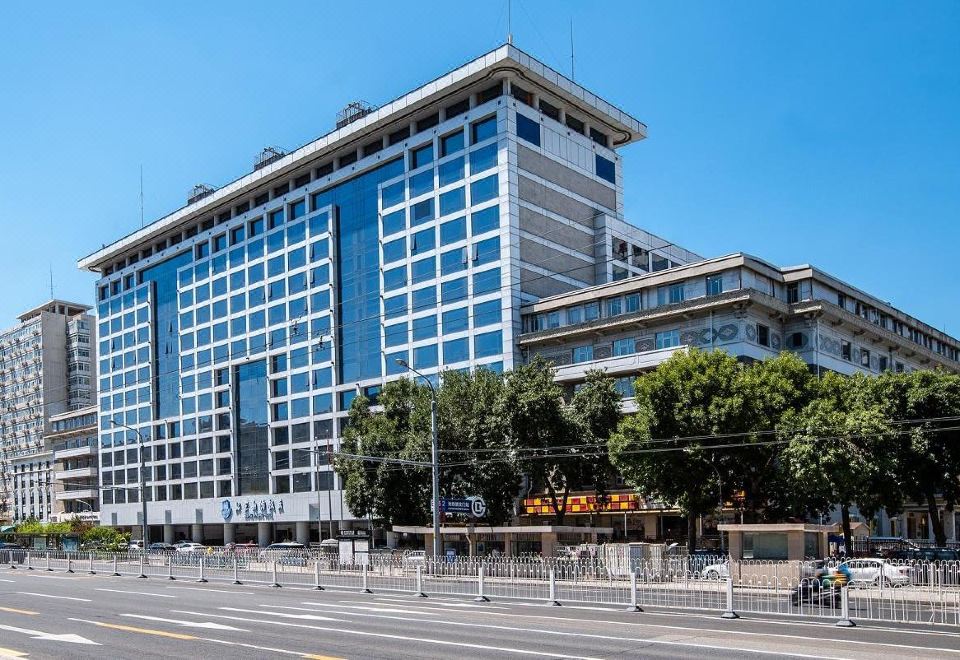 "There is a large building with an exterior view and the word ""hotel"" displayed on top located in front of" at Beijing Xinqiao Hotel