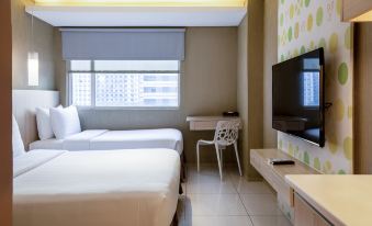 a modern hotel room with a white bed , two beds , a tv , and a desk at Hotel 101 Manila