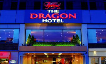 "a large building with a sign that reads "" the dragon hotel "" prominently displayed on the front" at The Dragon Hotel