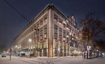 a large , modern building with a prominent sign on the front and snow - covered streets below at Vienna Marriott Hotel