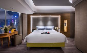There is a large bed in the middle room with an attached bathroom behind it, and there is also another bedroom at Elegant Hotel Shanghai Bund