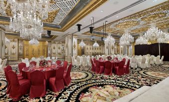A ballroom is prepared with tables and chairs for an event at the hotel or another location at Hotel Alexandra