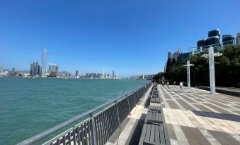 The walkway in front offers a view of the skyline and the blue ocean at Ramada Hong Kong Harbour View