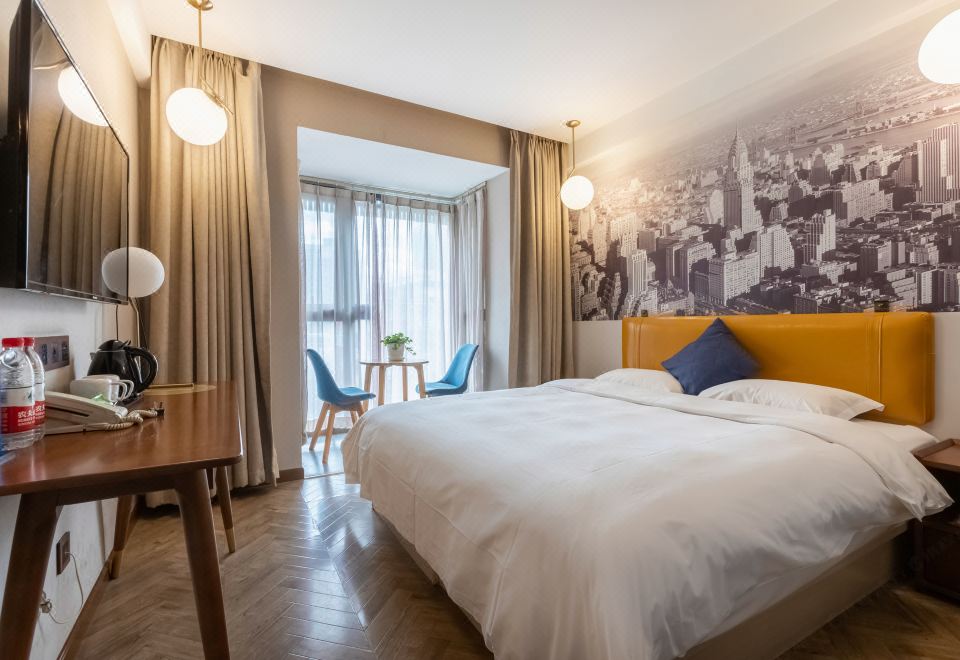The hotel room is equipped with a bed or beds, as well as a table and chairs placed close together at Super 8 Hotel Premier (Beijing Workers' Stadium Sanlitun Chunxiu Road)
