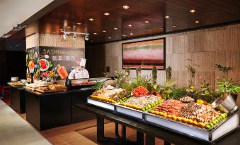A buffet is displayed in the center, featuring a wide variety of different types and sizes of food on each side at the Westin Guangzhou