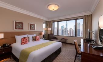 The middle room features a large bed with windows that overlook other rooms and offer an ocean view at Okura Garden Hotel Shanghai