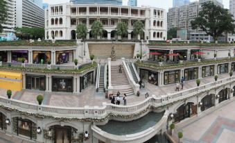 There is a large shopping mall in the center with people and buildings, as well as other shops at Imperial Hotel
