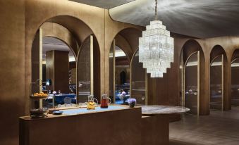 The restaurant features tables and chandeliers in the center, as well as an open concept at Blossom House Shanghai On The Bund