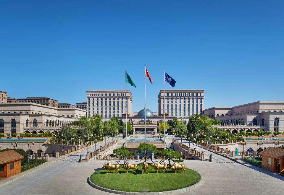 There is a large building with a main square in front and another hotel located behind it at Guoce International Conference and Exhibition Center