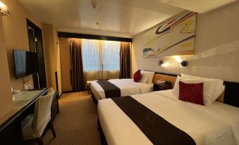 The bedroom features two beds and an attached bathroom, with the bed neatly made at Best Western Plus Hotel Kowloon