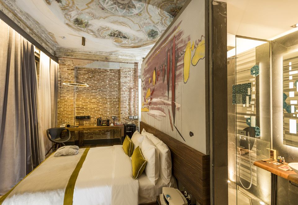 a modern bedroom with a large bed , a desk , and a mural on the wall at Hotel the Public - Special Category