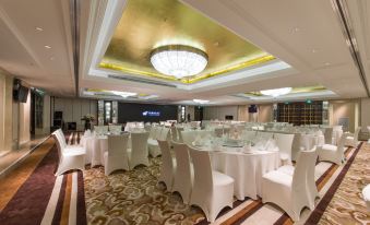 A ballroom is set up with tables and chairs for an event at the hotel or another location at Boyue Hotel Shanghai Air China Hongqiao Airport