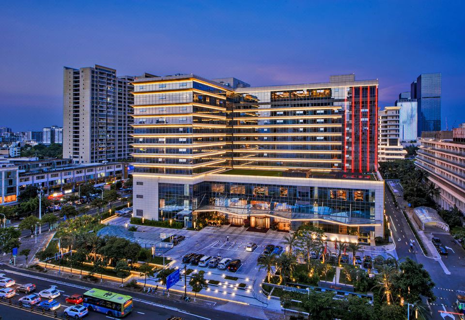 At night, a large building in the middle is illuminated by streetlights, offering an outside view at Orchid Sea Hotel