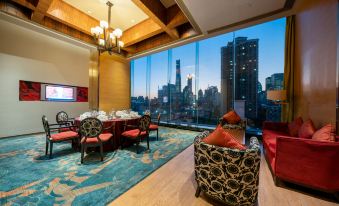 The room features large windows and floor-to-ceiling glass, providing an elegant dining experience with a view of the city at The Eton Hotel Shanghai