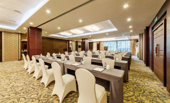 a large conference room with rows of chairs arranged in a semicircle , ready for a meeting or event at Swan Hotel