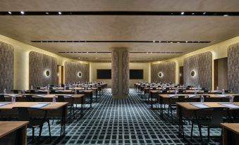 A restaurant is equipped with tables and chairs arranged in the central room, specifically designed for business meetings at Blossom House Shanghai On The Bund