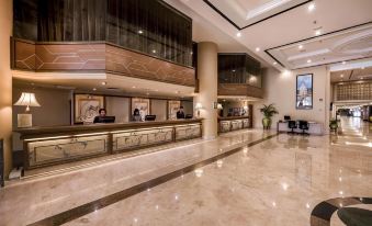 a modern hotel lobby with marble floors and a reception desk , surrounded by comfortable seating areas at Cititel Penang