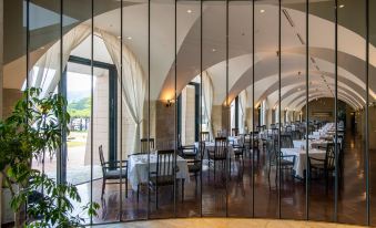 a modern restaurant with large windows and a glass wall , allowing natural light to fill the space at Hakone Hotel