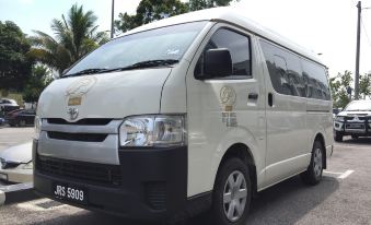 "a white van with the words "" jbsen "" on it is parked on a street next to palm trees" at Sem9 Senai "Formerly Known As Perth Hotel"