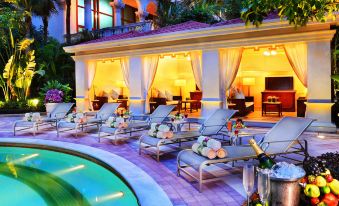 There is a spacious swimming pool with accompanying chairs and tables located adjacent to the patio at a luxurious resort at The Venetian Macao