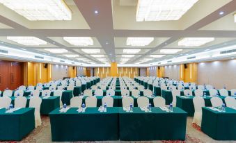 a ballroom with tables and chairs arranged for an event at Metropark Jichen Hotel Shanghai