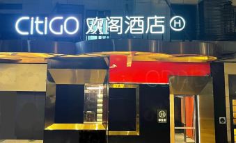 There is a restaurant entrance with a sign above it and an illuminated doorway at CITIGO hotel, Sanlitun, Beijing
