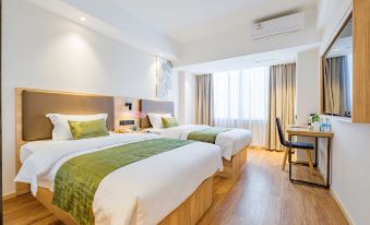 The bedroom is equipped with two double beds and a large table for daytime use at Greentree Inn (Shanghai Jingan)