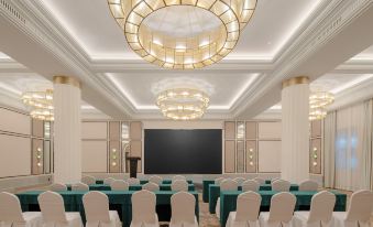 A spacious event room is arranged with tables and chairs positioned at the front at Grand Madison Wuhan Hankou on the Bund