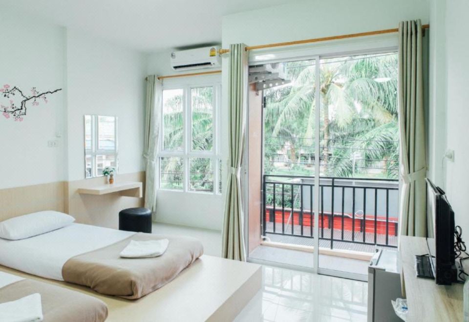 a hotel room with a bed , desk , and sliding glass door leading to a balcony at Cheaper Room