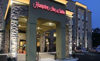 "the exterior of a hotel called "" hampton inn & suites "" with its large archway entrance" at Hampton Inn & Suites by Hilton Stroudsburg Pocono Mountains