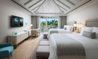 a hotel room with two beds , one on the left side of the room and the other on the right side at The St. Regis Bahia Beach Resort, Puerto Rico
