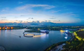 The city's bay and surrounding land are illuminated at night at Continental Bridge Convention Centre Lianyungang China
