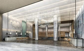 The lobby features a large, modern chandelier and glass panels on both sides at Four Points by Sheraton Hong Kong Tung Chung