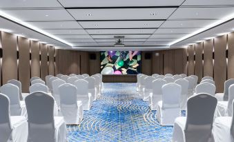 A spacious room is arranged with rows of white chairs for an event or function at Radisson Collection Hotel, Yangtze Shanghai