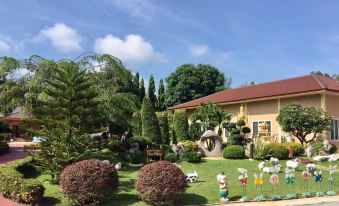 a beautiful garden with a variety of plants and trees , as well as various animals such as horses , cows , and elephants at Tokyo Hotel