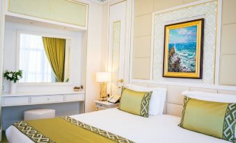 a spacious bedroom with a double bed and a large window that offers a beautiful view of the beachfront at Yyldyz Hotel