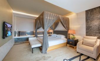 The middle room features a large bed with an attached sitting area and a canopy at Mission Hills Resorts Shenzhen