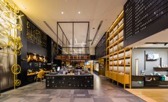 The restaurant features an open concept design, connecting the lobby and bar area seamlessly with its main dining room at CitiGO Hotel Jing'an Shanghai