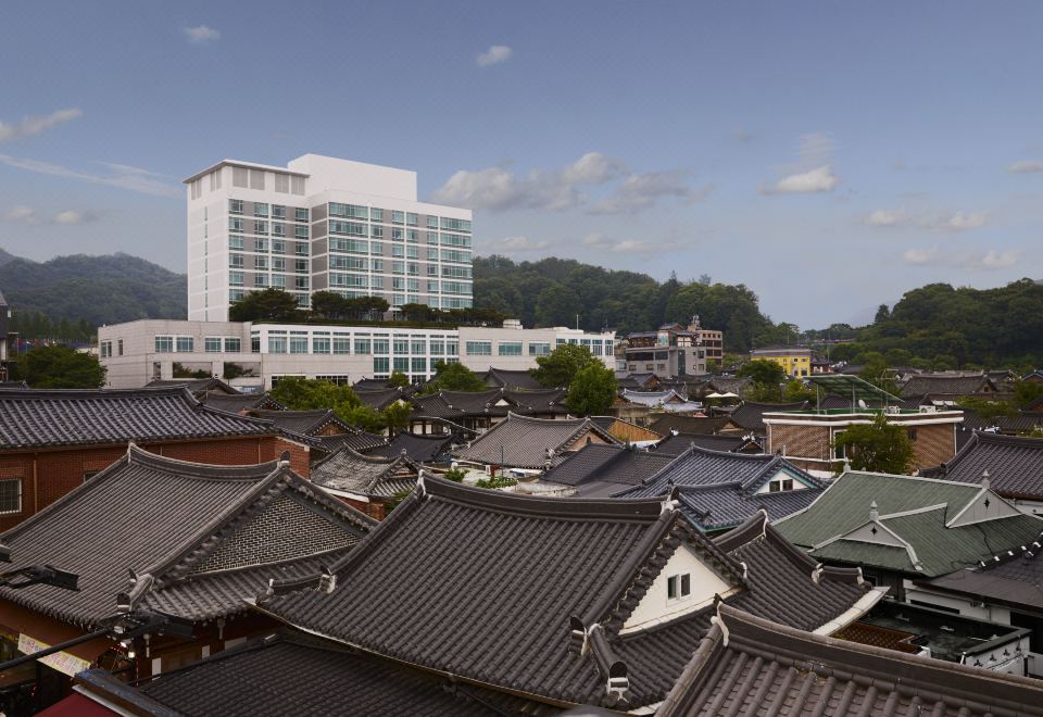 a cityscape with a mix of modern and traditional buildings , including a large building in the background at Lahan Hotel Jeonju