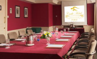 a conference room set up for a meeting , with tables and chairs arranged in a semicircle at Castle Hotel Macroom