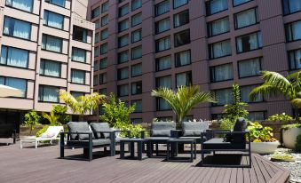 a modern hotel with multiple balconies , providing a comfortable outdoor seating area for guests to enjoy at Grand Millennium Auckland