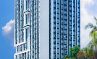 A building with tall windows and an office tower in the middle on top is commonly referred to as a large building at Landmark Vientiane Life Center